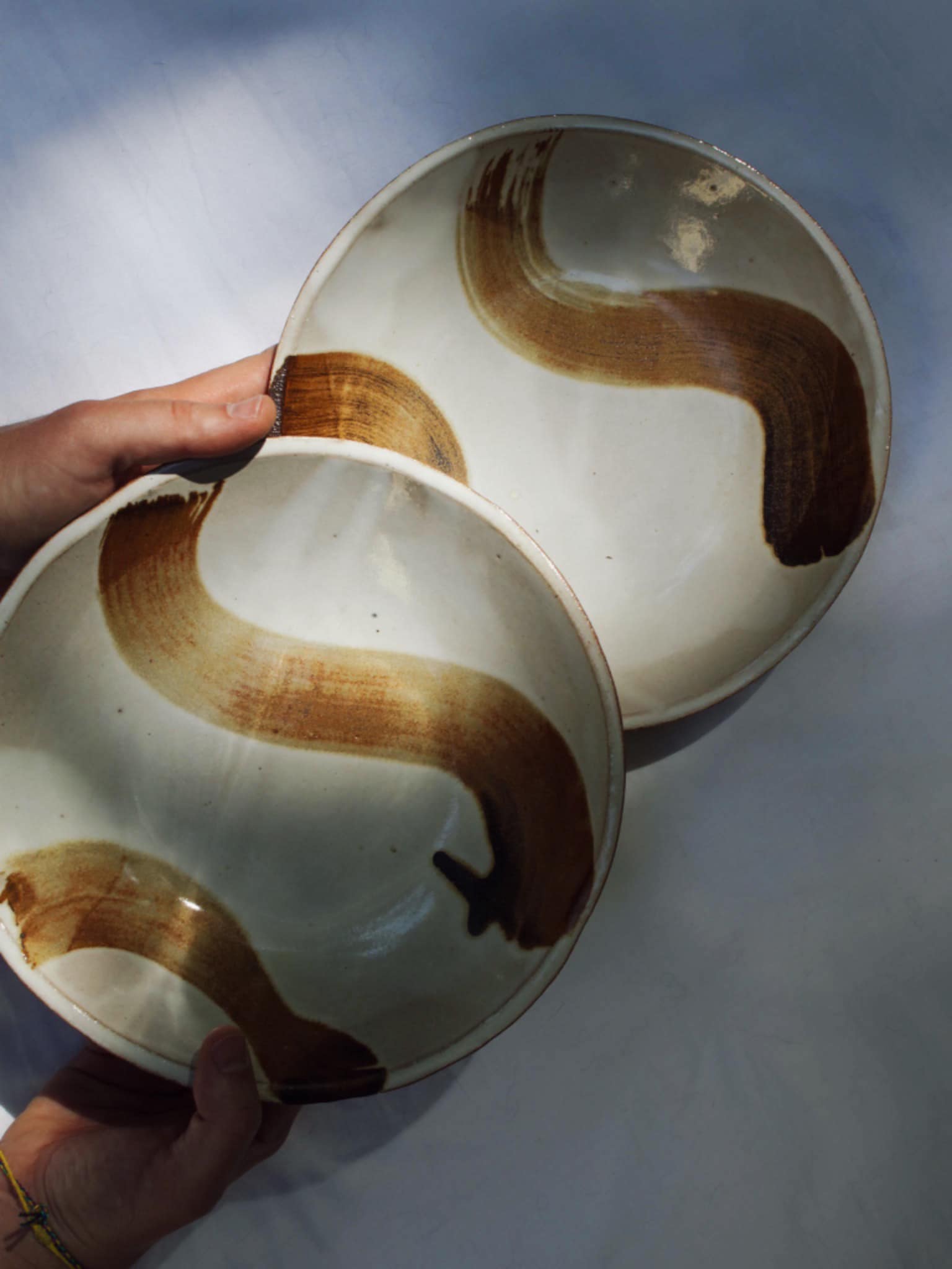 handmade ceramic pasta plates with iron oxide brushstrokes